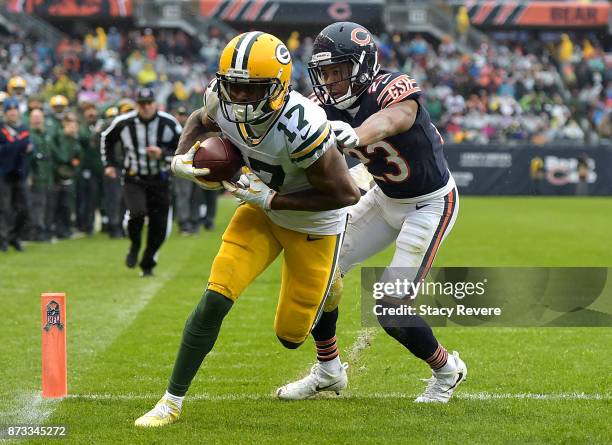 Davante Adams of the Green Bay Packers completes the pass against Kyle Fuller of the Chicago Bears for a touchdown in the fourth quarter at Soldier...