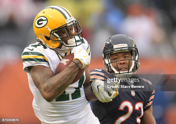 Davante Adams of the Green Bay Packers completes the pass while being guarded by Kyle Fuller of the Chicago Bears in the fourth quarter at Soldier...