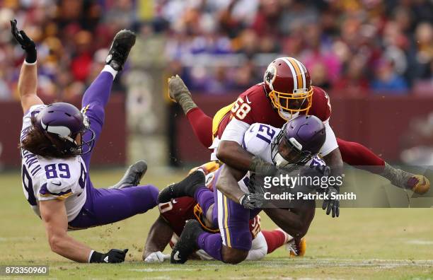 Running back Jerick McKinnon of the Minnesota Vikings is tackled by linebacker Junior Galette of the Washington Redskins during the fourth quarter at...
