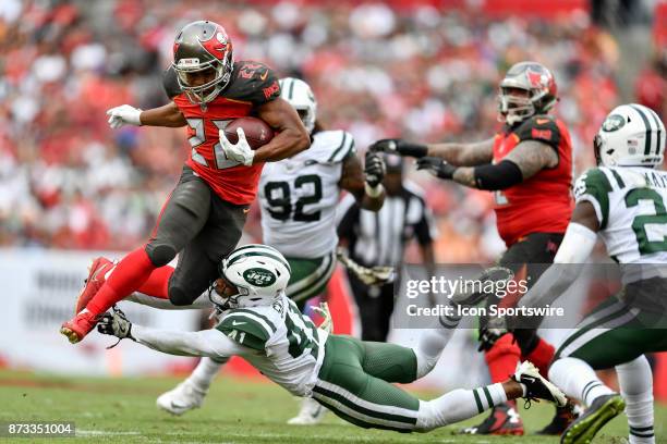 Tampa Bay Buccaneers running back Doug Martin tries to leap over the tackle by New York Jets cornerback Buster Skrine during the second half of an...