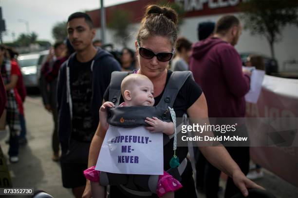 Sharilyn Fields and her 6-month-old daughter Lily participate in the #MeToo Survivors' March in response to several high-profile sexual harassment...