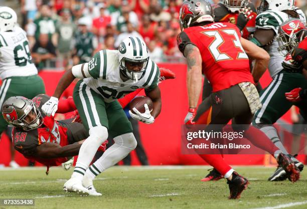 Running back Bilal Powell of the New York Jets finds room to run between middle linebacker Kwon Alexander of the Tampa Bay Buccaneers and free safety...