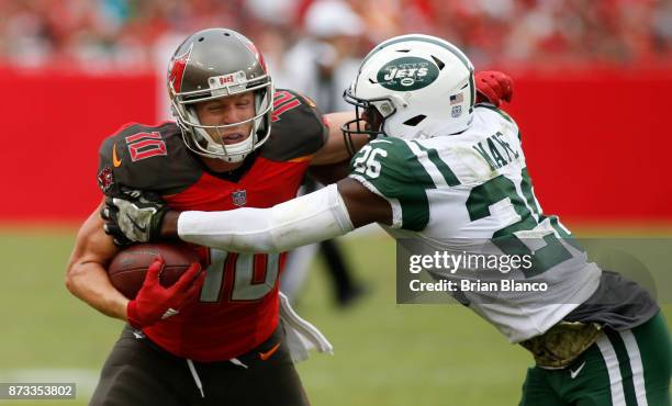 Wide receiver Adam Humphries of the Tampa Bay Buccaneers is tackled by free safety Marcus Maye of the New York Jets after hauling in a pass from...