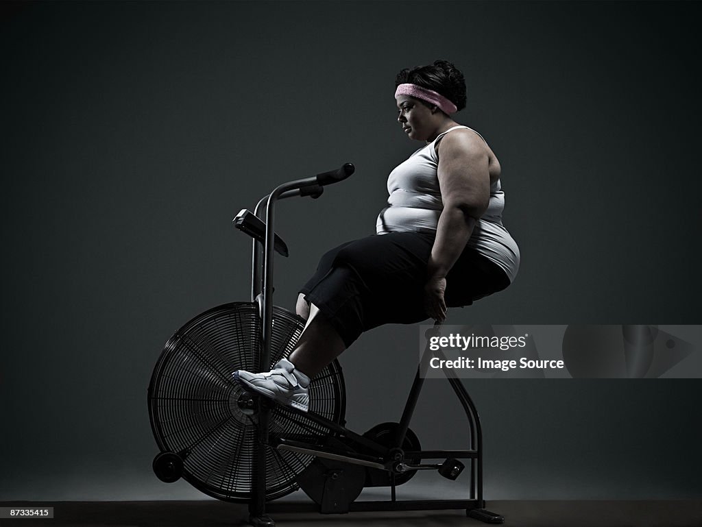 Overweight woman on exercise bike