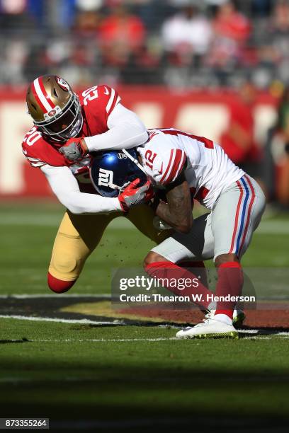 Leon Hall of the San Francisco 49ers tackles Tavarres King of the New York Giants during their NFL game at Levi's Stadium on November 12, 2017 in...