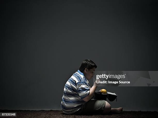 boy eating packed lunch - eating secret stockfoto's en -beelden