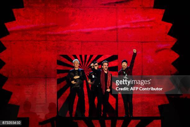 Irish rock band U2, Bono , The Edge , Adam Clayton and Larry Mullen Jr , accept the global icon award during the 2017 MTV Europe Music Awards at...