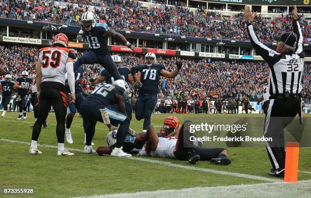 Rishard Matthews and Jack Conklin of the Tennessee Titans celebrate as teammate DeMarco Murray lays on the turf after scoring the game winning...