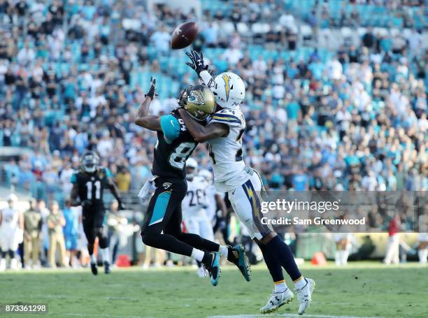 Keelan Cole of the Jacksonville Jaguars reaches for the football in front of Trevor Williams of the Los Angeles Chargers in the second half of their...