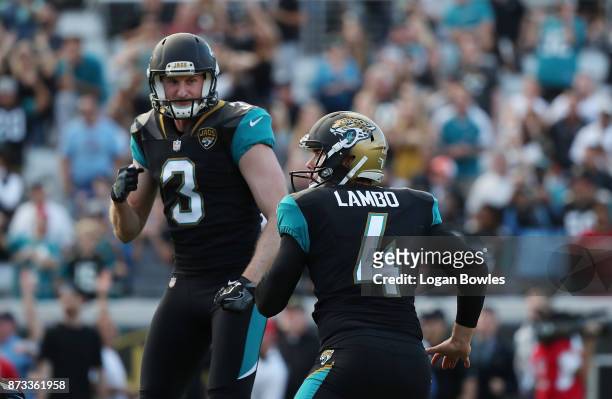 Josh Lambo and Brad Nortman of the Jacksonville Jaguars celebrate after Lambo made a 30-yard field goal in overtime as the Jaguars defeated the Los...