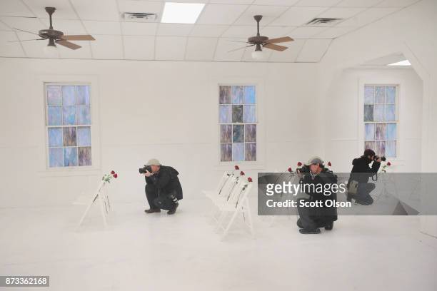 News photographers takes pictures inside of the First Baptist Church of Sutherland Springs which has been turned into a memorial to honor those who...