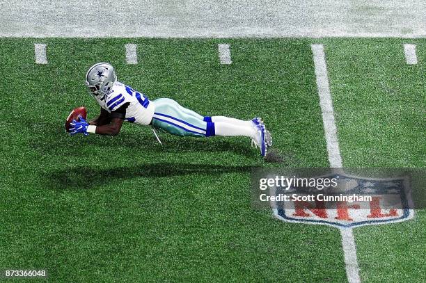 Xavier Woods of the Dallas Cowboys makes an interception during the first half against the Atlanta Falcons at Mercedes-Benz Stadium on November 12,...