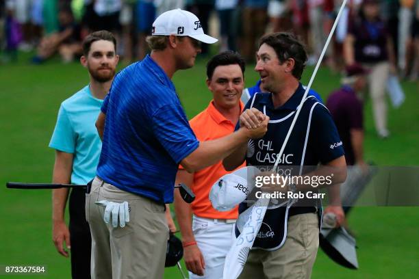 Patton Kizzire of the United States celebrates with caddie Joe Etter on the 18th green after winning during the final round of the OHL Classic at...