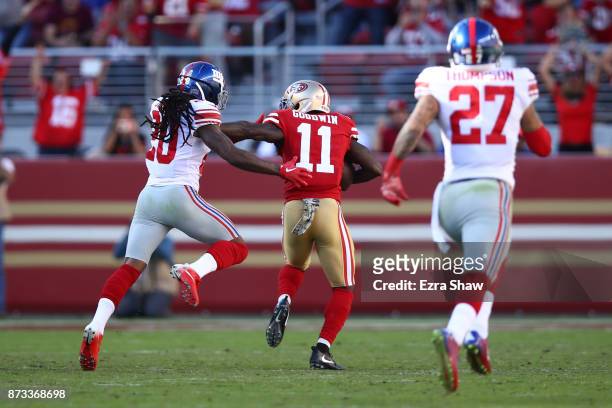Marquise Goodwin of the San Francisco 49ers breaks a tackle from Janoris Jenkins of the New York Giants on his way to an 83-yard touchdown against...