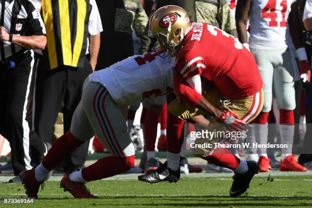 Beathard of the San Francisco 49ers is hit by Eli Apple of the New York Giants during their NFL game at Levi's Stadium on November 12, 2017 in Santa...