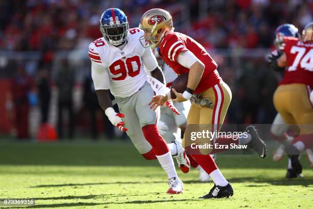Jason Pierre-Paul of the New York Giants persues C.J. Beathard of the San Francisco 49ers during their NFL game at Levi's Stadium on November 12,...