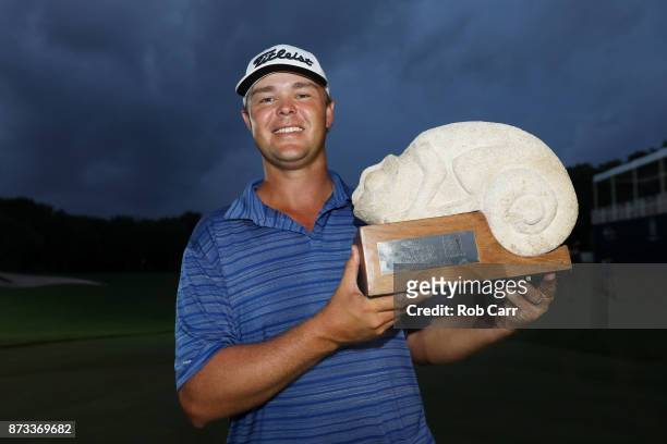 Patton Kizzire of the United States celebrates with the trophy on the 18th green after winning during the final round of the OHL Classic at Mayakoba...