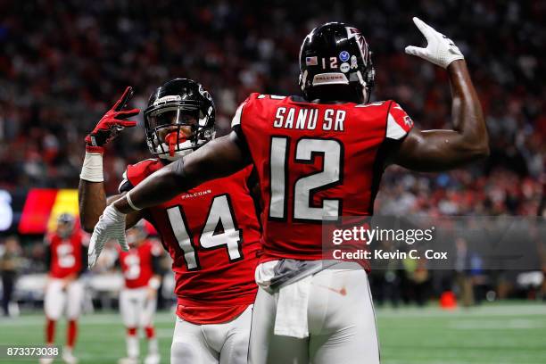 Justin Hardy of the Atlanta Falcons celebrates a touchdown with Mohamed Sanu during the second half against the Dallas Cowboys at Mercedes-Benz...