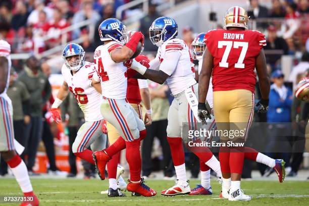 Olivier Vernon of the New York Giants celebrates after intercepting a pass by C.J. Beathard of the San Francisco 49ers during their NFL game at...