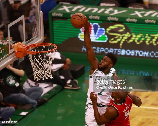Jaylen Brown of the Boston Celtics goes up for a dunk over Serge Ibaka of the Toronto Raptors in the second quarter of the game at TD Garden on...