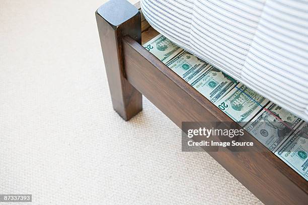 money hidden under a mattress - hiding money stock pictures, royalty-free photos & images