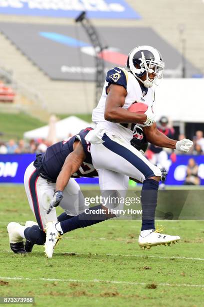 Pharoh Cooper of the Los Angeles Rams attempts to get around Kurtis Drummond of the Houston Texans during the NFL game at the Los Angeles Memorial...