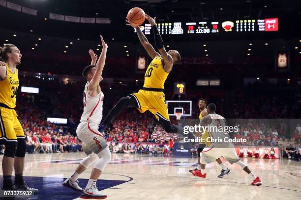 Jairus Lyles of the UMBC Retrievers shoots against Alex Barcello of the Arizona Wildcats during the first half of the college basketball game at...