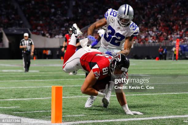 Austin Hooper of the Atlanta Falcons is tackled by Orlando Scandrick of the Dallas Cowboys short of the end zone during the second half at...