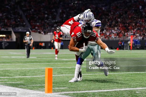 Austin Hooper of the Atlanta Falcons is tackled by Orlando Scandrick of the Dallas Cowboys short of the end zone during the second half at...