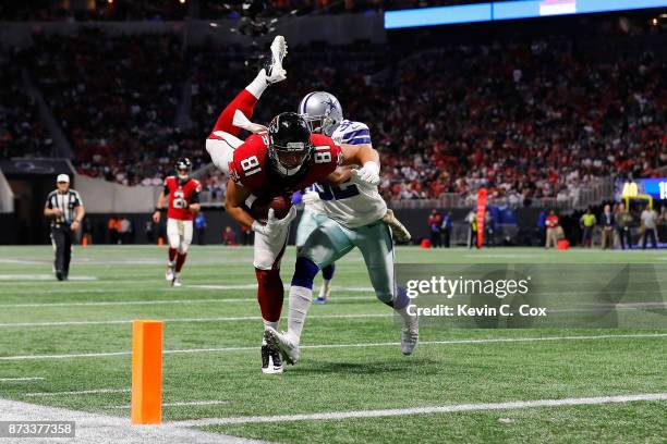 Austin Hooper of the Atlanta Falcons is tackled by Orlando Scandrick of the Dallas Cowboys short of the end zone during the second half at...