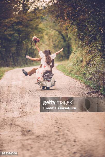 happy young couple enjoying on vintage vespa motorcyle - riding vespa stock pictures, royalty-free photos & images