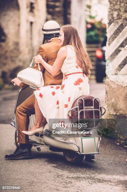 happy young couple enjoying on vintage vespa motorcyle - riding vespa stock pictures, royalty-free photos & images