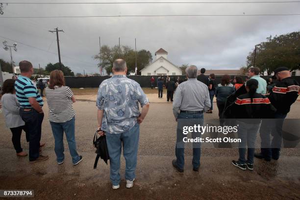 Visitors wait in line to tour the First Baptist Church of Sutherland Springs after it was turned into a memorial to honor those who died on November...