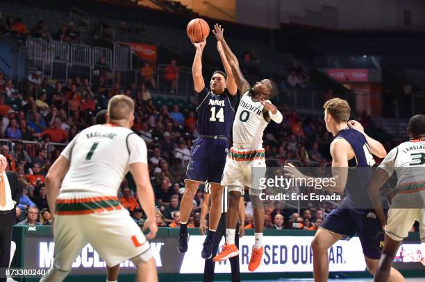 Bryce Dulin of the Navy Midshipmen shoots the basketball during the first half against the Miami Hurricanes at The Watsco Center on November 12, 2017...