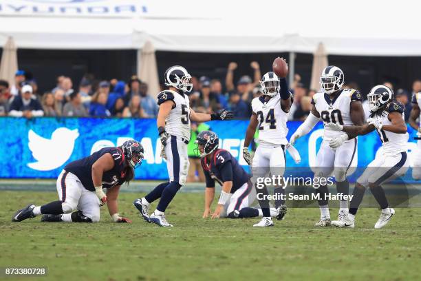 Bryce Hager and Michael Brockers of the Los Angeles Rams congratulate Blake Countess of the Los Angeles Rams after his interception as Xavier...