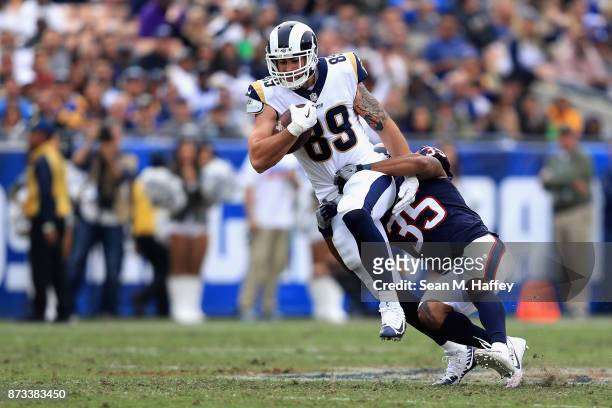 Tyler Higbee of the Los Angeles Rams is tackled by Eddie Pleasant of the Houston Texans on a pass play during the second half of game at Los Angeles...