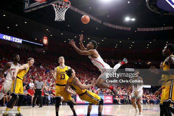Allonzo Trier of the Arizona Wildcats shoots over Max Portmann of the UMBC Retrievers during the second half of the college basketball game at McKale...