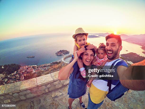 family with two little daughters travel in nature, making selfie, smiling - go pro camera imagens e fotografias de stock