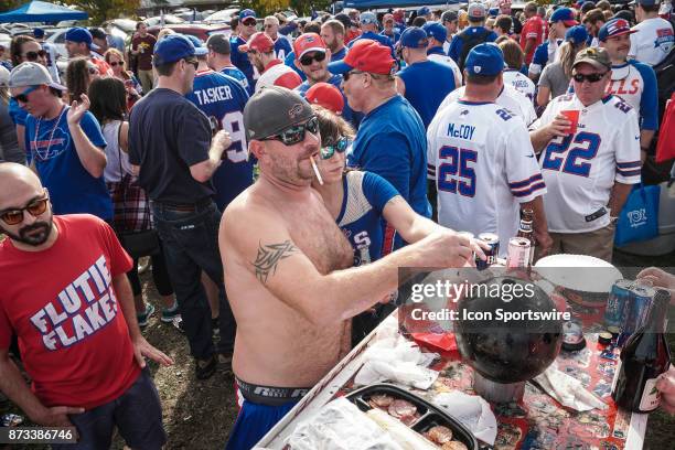 Buffalo Bills fans prepare to do a shot of traditional Polish cherry vodka from a bowling ball while tailgating at the Hammer's Lot at the Pinto Ron...