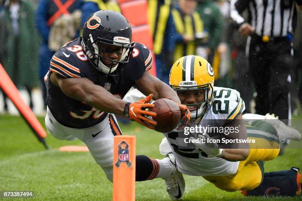 Chicago Bears running back Benny Cunningham battles with Green Bay Packers defensive back Marwin Evans to dive into the endzone for an attempted...