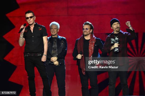 Bono, The Edge, Adam Clayton and Larry Mullen Jr accept the global icon award on stage during the MTV EMAs 2017 held at The SSE Arena, Wembley on...