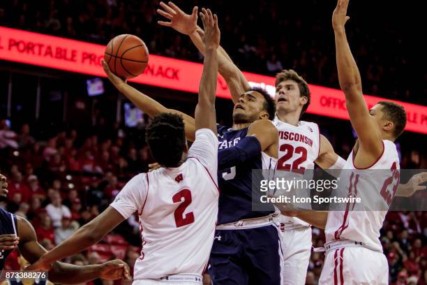 Yale Bulldogs guard Alex Copeland gets fouled going up for a shot against Wisconsin Badger forward Aleem Ford , Wisconsin Badger forward Ethan Happ ,...