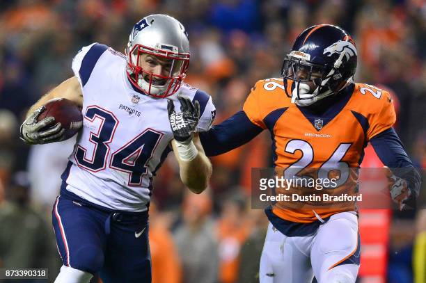 Running back Rex Burkhead of the New England Patriots runs for a touchdown after a catch in the first quarter of a game as free safety Darian Stewart...
