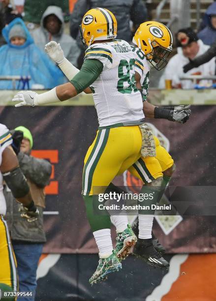 Richard Rodgers and Ty Montgomery of the Green Bay Packers celebrate a touchdown run by Mongomery against the Chicago Bears at Soldier Field on...