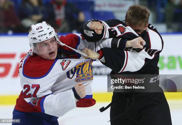 Brad Morrison of the Vancouver Giants fights Trey Fix-Wolanski of the Edmonton Oil Kings during the third period of their WHL game at the Langley...