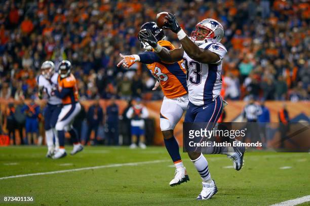 Tight end Dwayne Allen of the New England Patriots catches a pass before scoring a second quarter touchdown under coverage by outside linebacker Von...