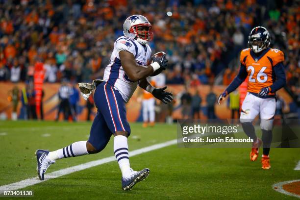 Tight end Dwayne Allen of the New England Patriots scores a second quarter touchdown against the Denver Broncos at Sports Authority Field at Mile...