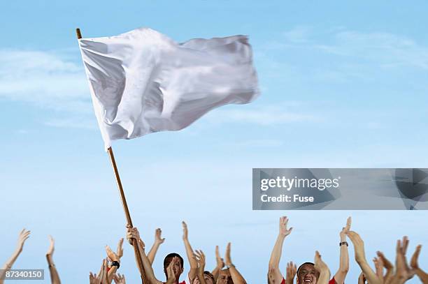 spectators waving a white flag at a sporting event - white flag stock pictures, royalty-free photos & images
