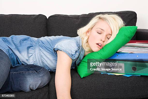 female student sleeping on sofa - one young woman only photos et images de collection