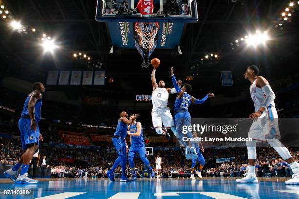 Paul George of the Oklahoma City Thunder goes up for a dunk against the Dallas Mavericks on November 12, 2017 at Chesapeake Energy Arena in Oklahoma...